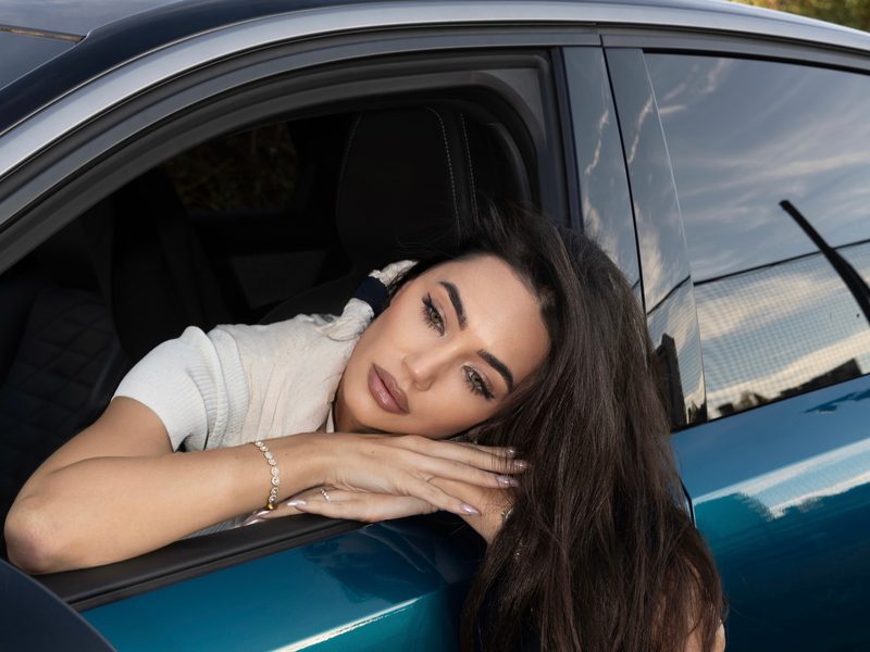 Dubravka Švegar resting on the open window of a blue car